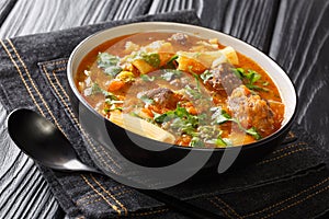 Soup joumou is a famous mildly spicyÃÂ soupÃÂ native to Haitian cuisine closeup in the plate. Horizontal